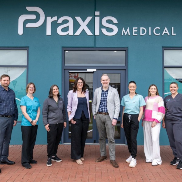 The Praxis Medical team standing in front of the entrance